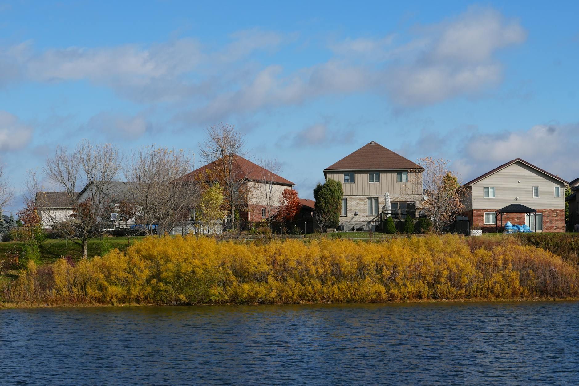 The view across a artificial suburban pond in early fall. Probably around 9AM.