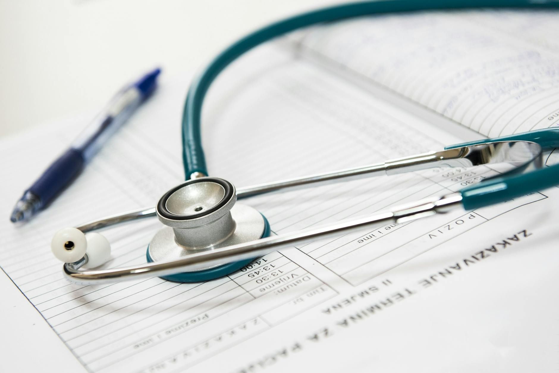 A close up of a stethoscope laid down on an empty charting paper